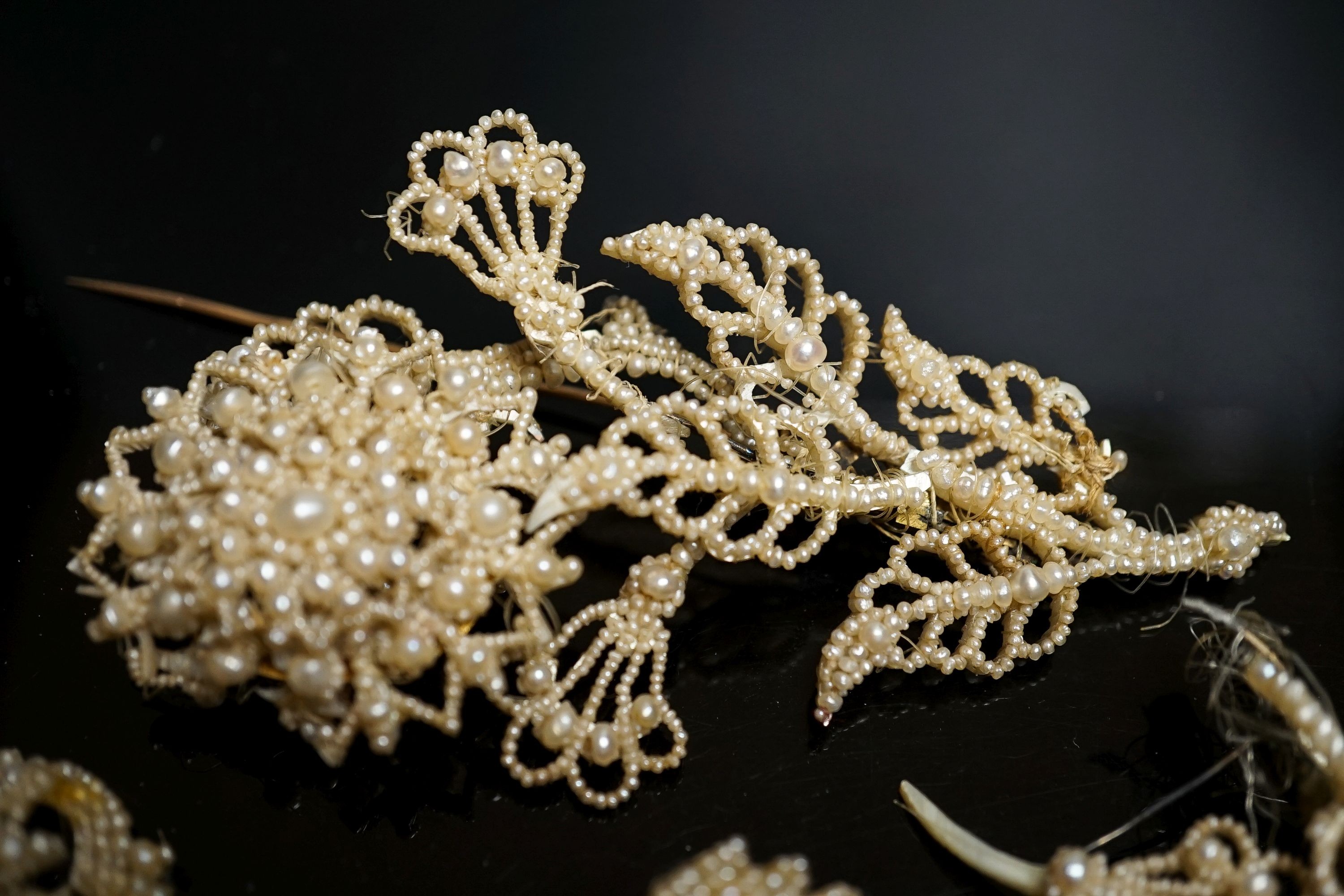 A 19th century seed pearl set flower brooch, 95mm and five other pieces of seed pearl jewellery.